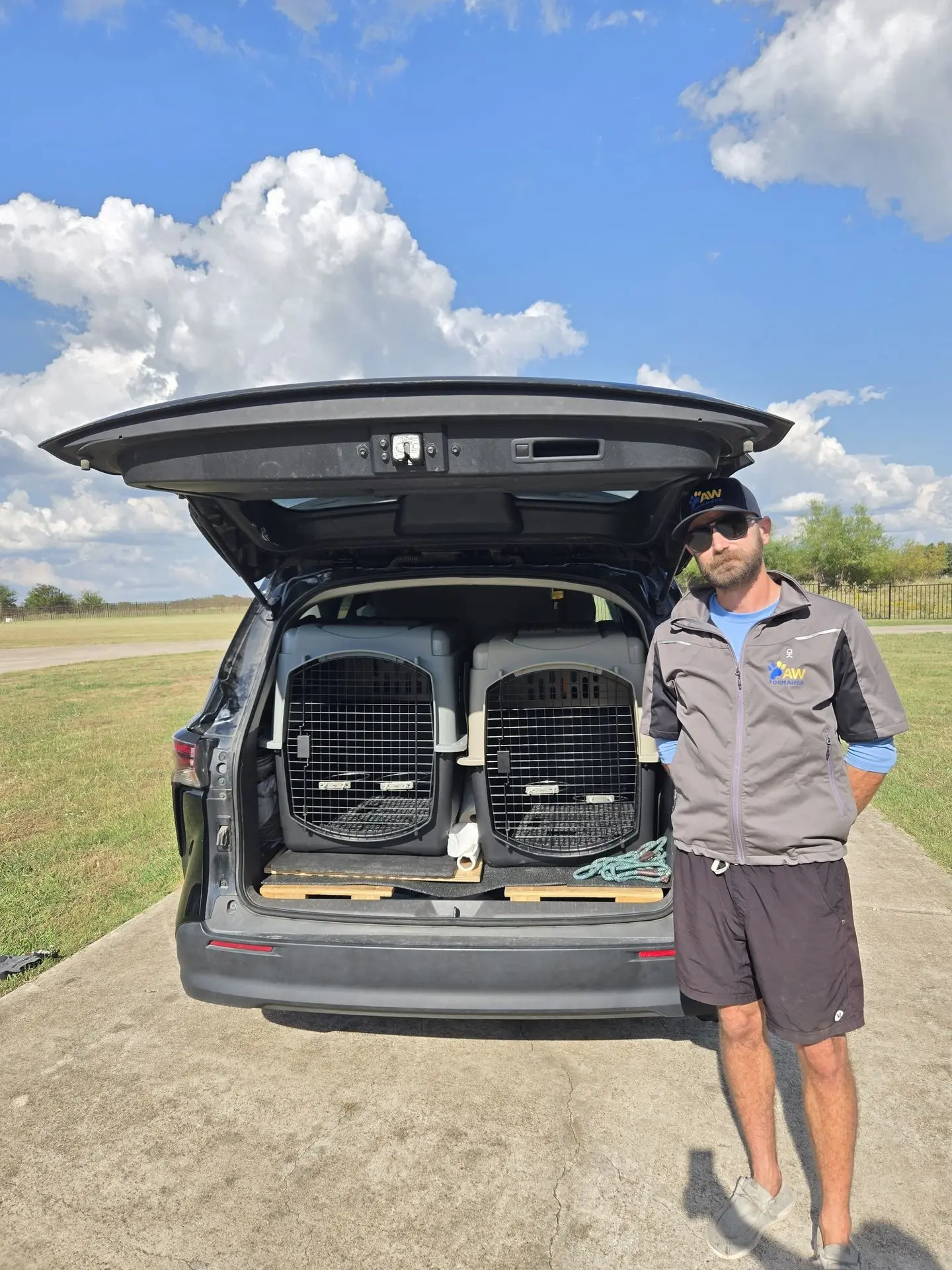 Pawformance pet transporter standing beside open vehicle ready for safe pet pickup and delivery.